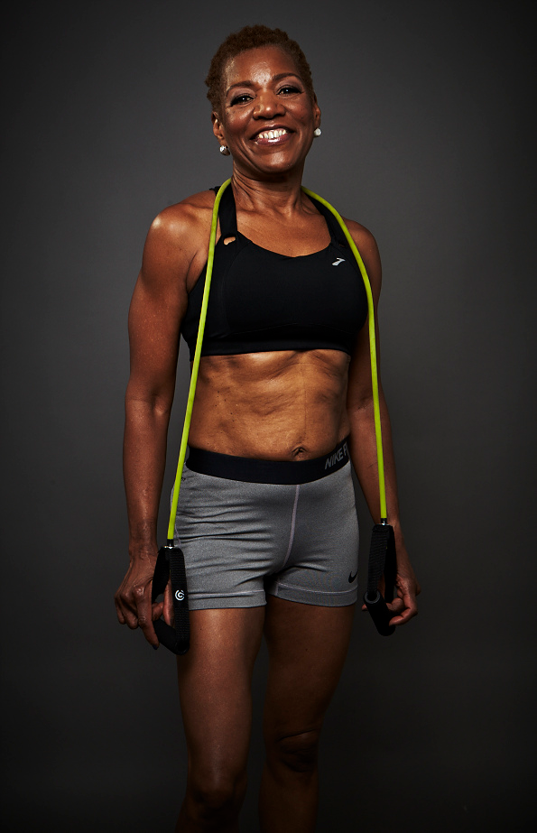 Coach smiling at the camera, dressed in athletic attire